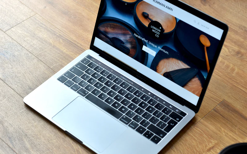 A laptop with a website open on a wooden desk